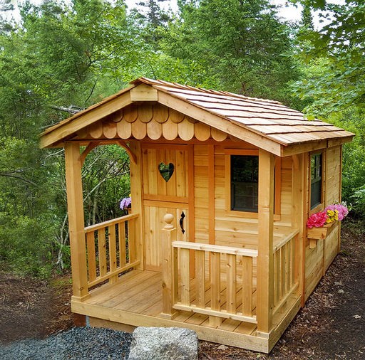 Outdoor Living Today Sunflower Playhouse with charming wooden details and blooming flower boxes in a natural forest setting