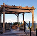 Outdoor Living Today Pergola with Retractable Canopy on a raised wooden deck with outdoor seating overlooking the ocean