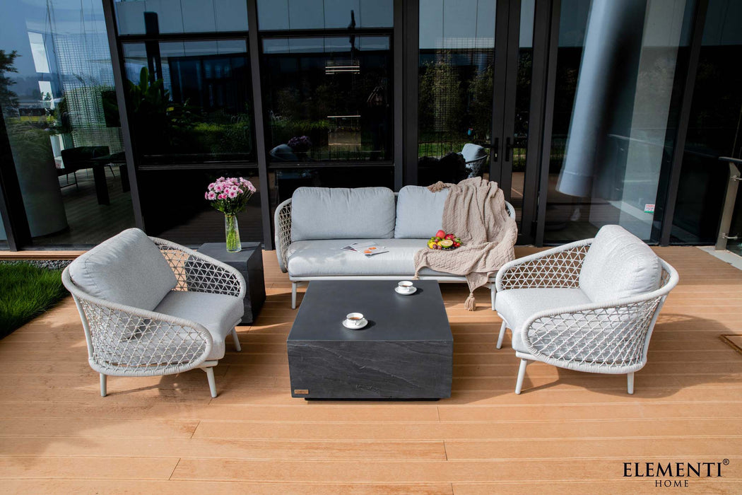 Slate black square medium coffee table from Elementi's Colorado Series, positioned on an outdoor patio surrounded by white and gray chairs.