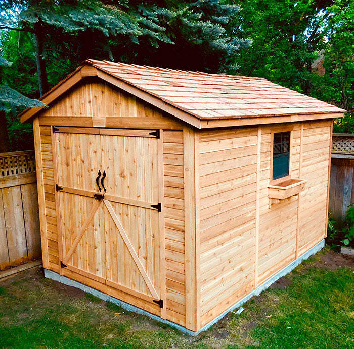 Outdoor Living Today Space Master 8x12 storage shed on a cement foundation in backyard setting