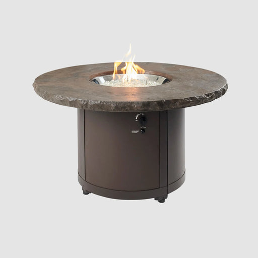 Outdoor Greatroom Co Beacon Round Gas Fire Pit Table lit with a visible flame, in Marbleized Noche color, SKU BC-20-MNB.