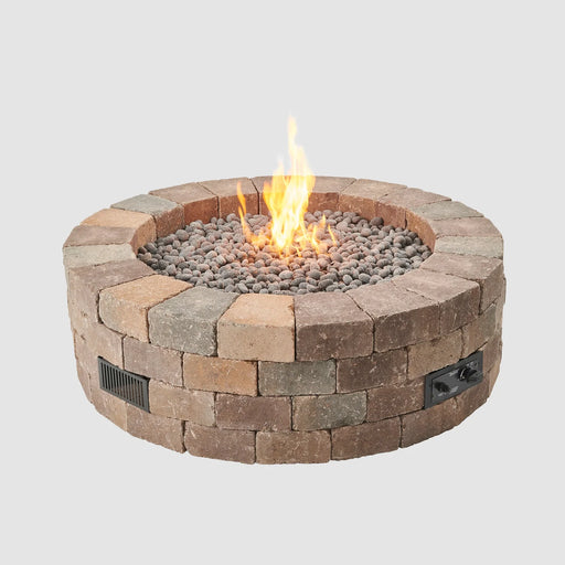 A warmly lit Outdoor Greatroom Co Bronson Block Gas Fire Pit Kit Round, perfect for evening gatherings, SKU BRON52-K.