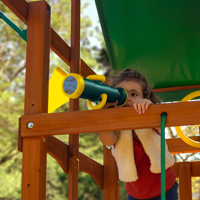 A child playing the telescope on the Outing With Monkey Bars Swing Set