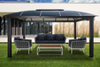 Cambridge Hard Top Gazebo in a contemporary outdoor setting with stylish black and white furniture.
