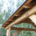Detailed view of the wooden support beams and aluminum roof of the Yardistry 11x13 Carolina Cedar Pavilion.