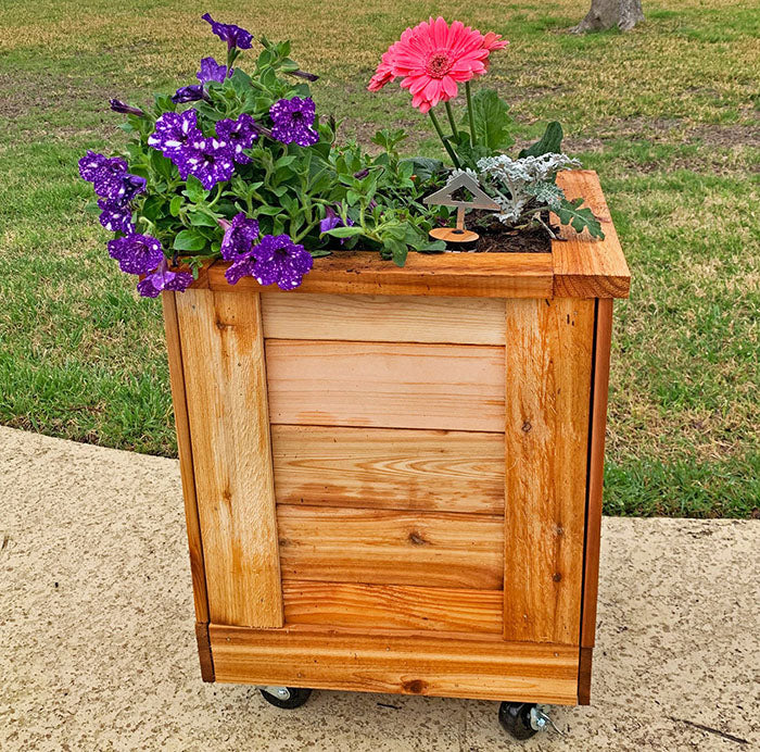 Outdoor Living Today Self Watering Planter 1×1 bursting with colorful flowers.