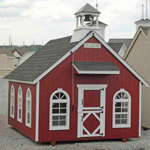 A picturesque front side angle view of the charming Stratford Schoolhouse Playhouse by Little Cottage Company.