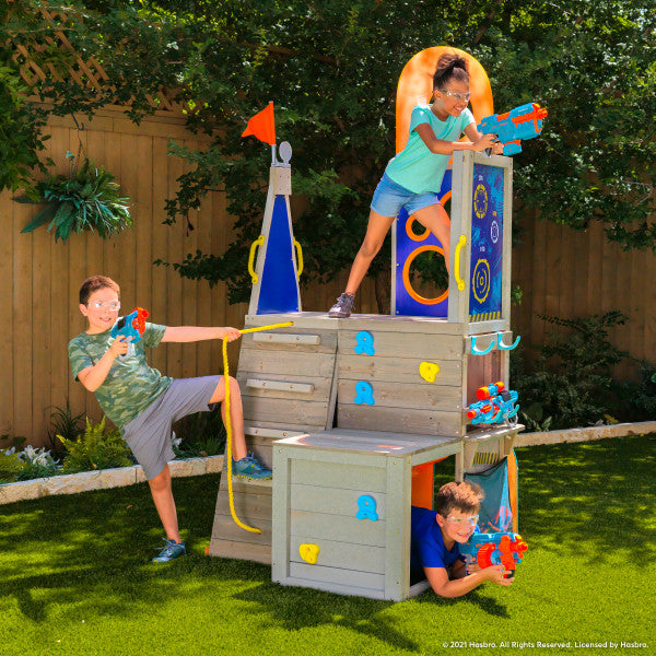 Outdoor wooden playset on a backyard with 3 kids