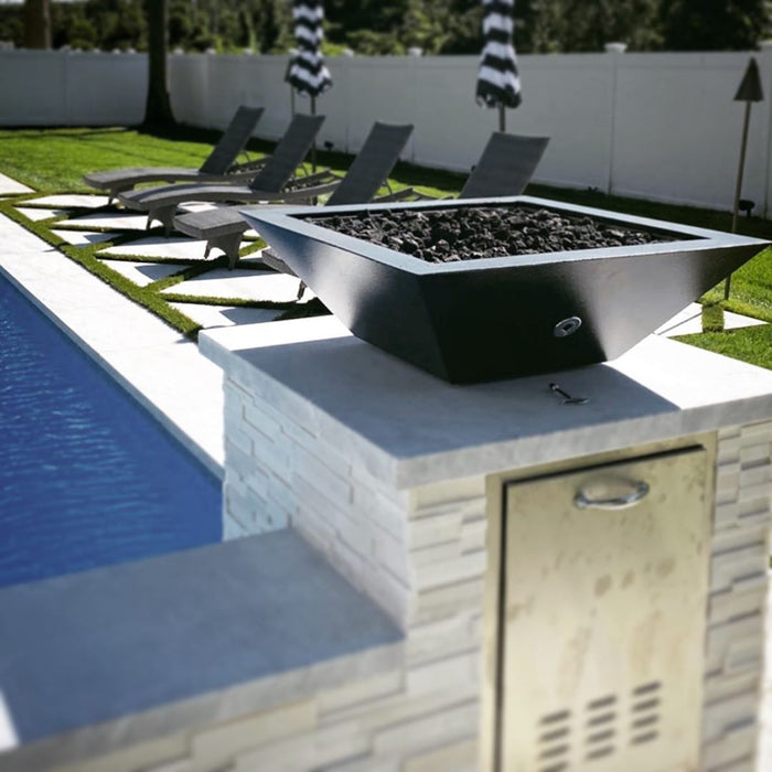 Contemporary poolside lounge area accentuated by a square GFRC concrete fire bowl, providing a cozy atmosphere.