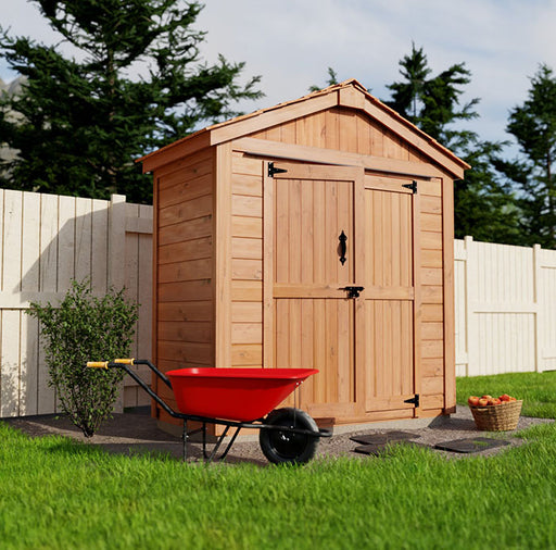 Red wheelbarrow next to the SpaceMaster 6x4 wooden garden shed with double doors and green lawn backdrop