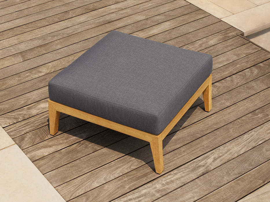 Single ottoman from the Rhodes 6 Seater Chat Set, showcasing a cast slate cushion atop a wooden frame, placed on wooden deck flooring.