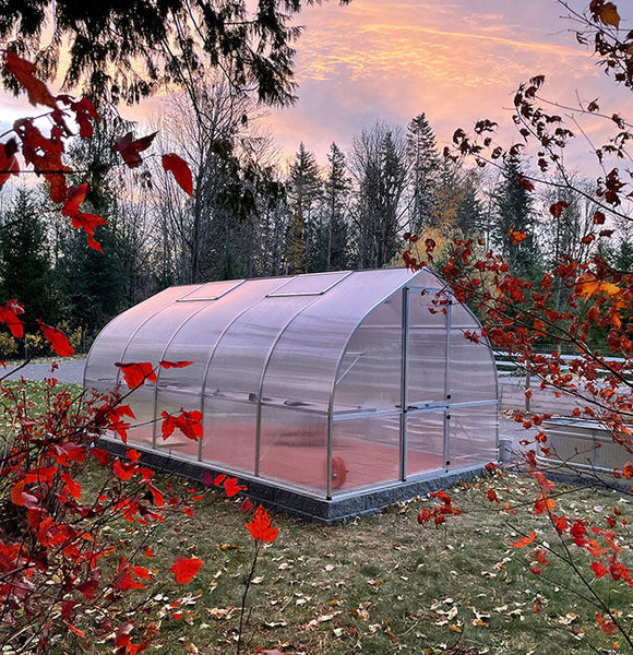 an actual product image of the Hoklartherm Riga Greenhouses 5 with flowers outside