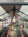 Interior view of the Hoklartherm Nelke Pro 4 Greenhouse, highlighting a turnbuckle used for roof reinforcement, ensuring added structural stability.