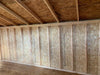 Inside view of the Saltbox Shed's robust wall structure with exposed OSB panels and wooden framing, illustrating the spacious interior ready for storage or workshop use.