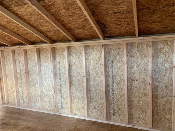 Inside view of the Saltbox Shed's robust wall structure with exposed OSB panels and wooden framing, illustrating the spacious interior ready for storage or workshop use.