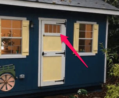 An EZ-Fit Shed with an Ez-Fit Transom Window Accessory - ADD-ON ONLY pointing to the door.