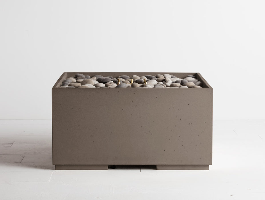 Shiitake light grey Solus Decor Firebox 30 combines a modern minimalist exterior with a natural pebble filling for a serene outdoor setting.