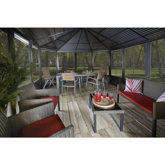 Sojag Charleston Solarium interior with table, chairs, and a couch, furnished for relaxation