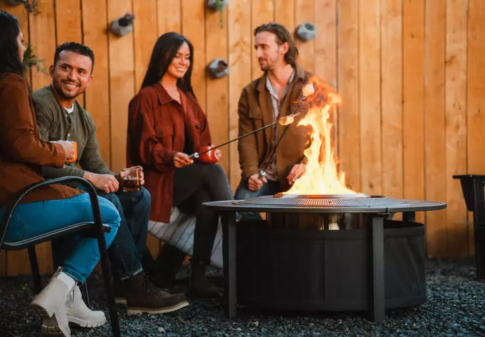 People around a Small	Fire Pit with Surround in the backyard.