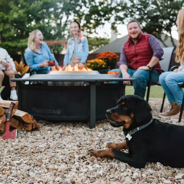 Family and dog around a Large Solo Stove Fire Pit Surround.