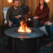 People around a small Solo Stove Fire Pit Surround.