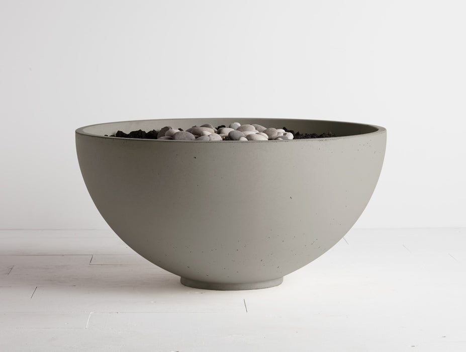 Nori Solus Hemi firebowl with adjustable flame, a bold concrete centerpiece for outdoor entertainment.