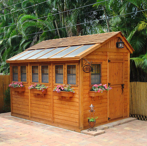 Warm, inviting wooden Sunshed garden shed by Outdoor Living Today, 8x12, featuring flower boxes and a charming rustic design, nestled in a tropical backyard setting.