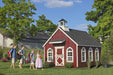 Children happily entering the Little Cottage Company Stratford Schoolhouse Playhouse in a lush garden setting.