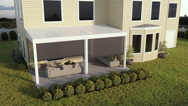 The Four Seasons Outdoor Living Solutions LifeRoom One - 20lb Snowload installed against the wall of a pale yellow house with the screens half open and outdoor furniture under the cover