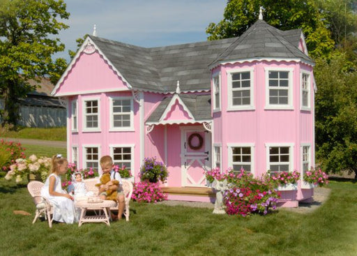 Tea party in front of a Little Cottage Company pink playhouse named Sara's Victorian Mansion Playhouse