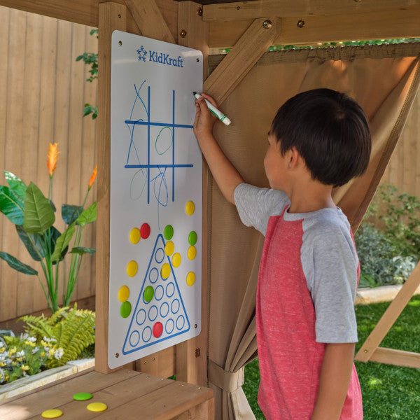 A kid playing tic tac toe on the clubhouse for kids