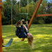Child swinging on the Cedar Treasure Trove II Swing Set