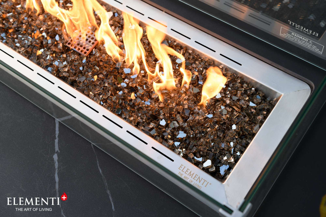 A close-up view of a fire pit featuring vibrant flames, showcasing the Bulgaria Black Valencia Porcelain Top Fire Table