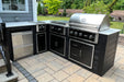 Wildfire Griddle with other Wildfire outdoor kitchen modular setup with stainless steel, black cabinetry, and a spacious countertop, set in a landscaped backyard.