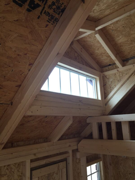 A view from inside the Craftsman Playhouse with Slide by Little Cottage Company, showcasing the charming window that fills the interior with natural light