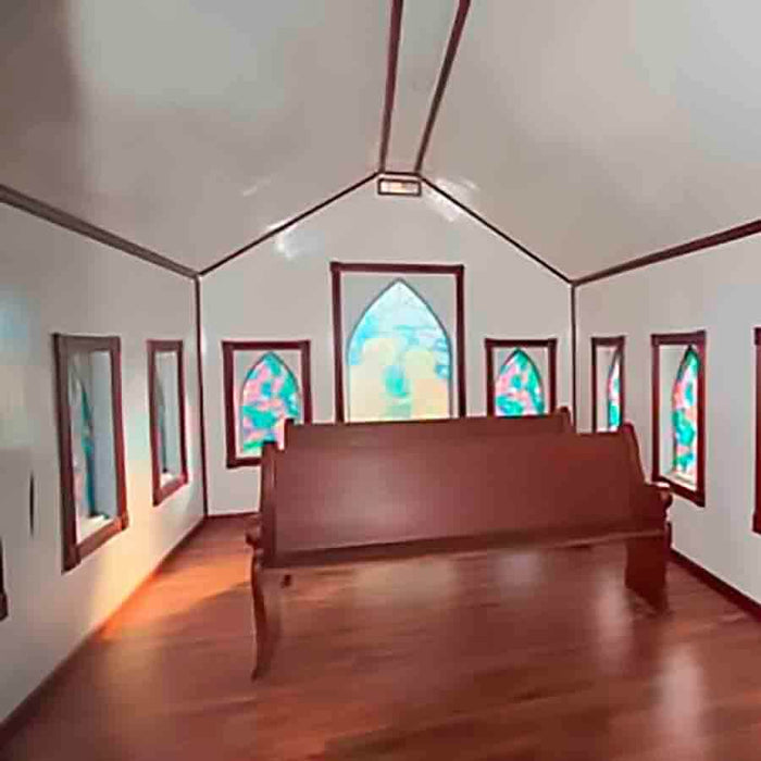 Interior of the Little Cottage Chapel Playhouse with benches.