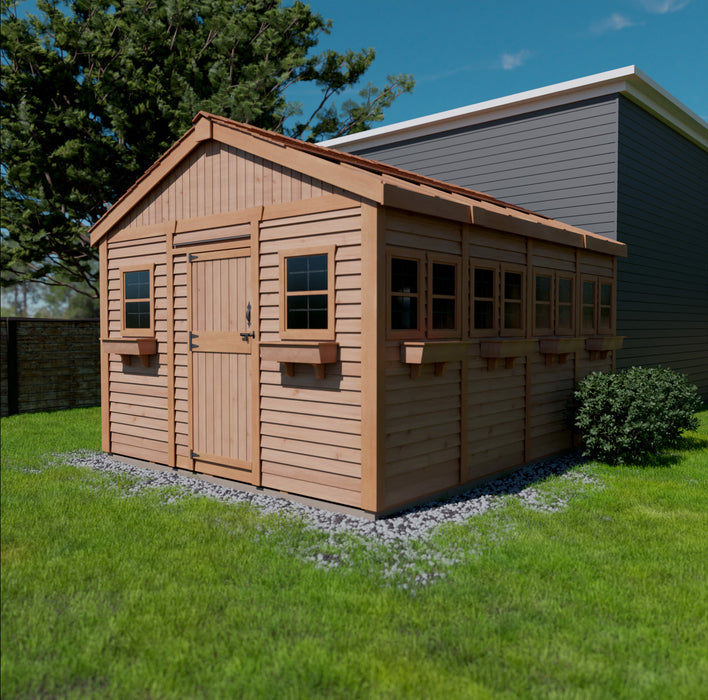 A wooden 12x16 Outdoor Living Today Sunshed storage shed with double doors, situated on a grassy lawn beside a stone pathway, under a clear sky.
