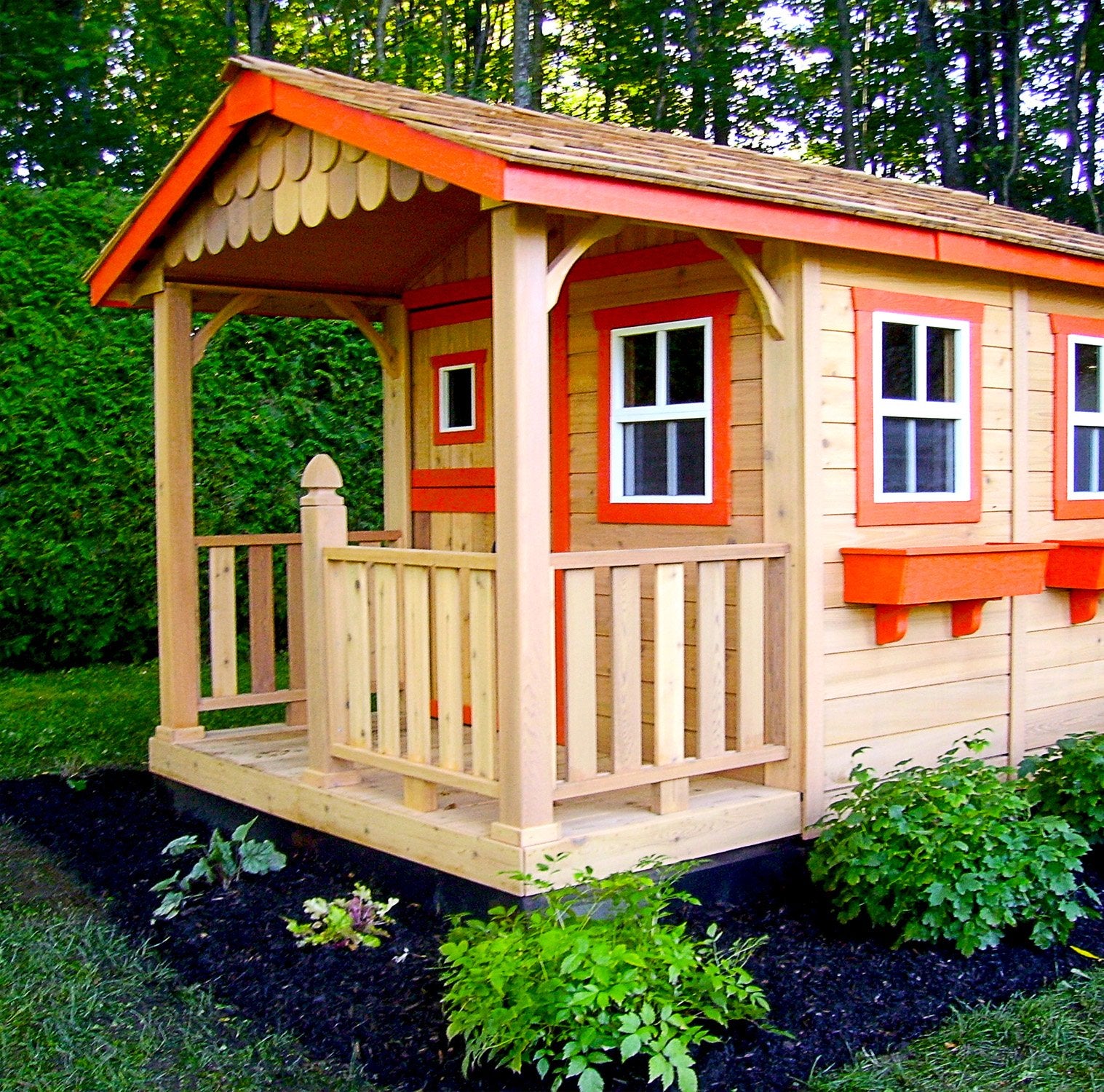 The Outdoor Living Today Cozy Cabin Playhouse with railings painted white. This small wooden playhouse adds charm to a backyard.