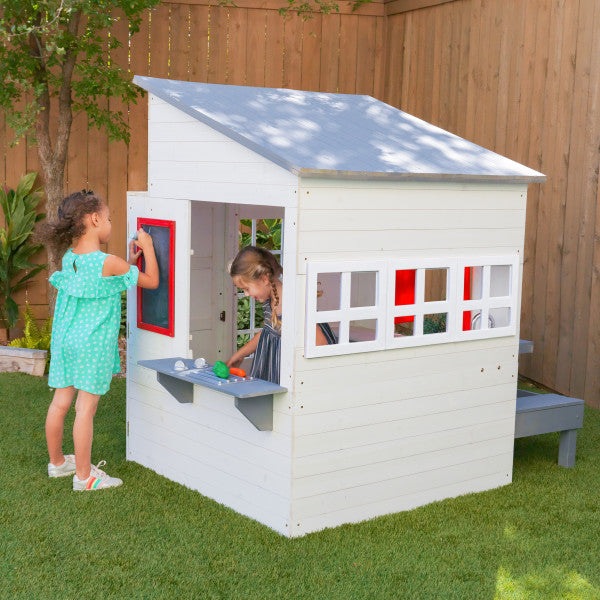 White modern playhouse on a backyard