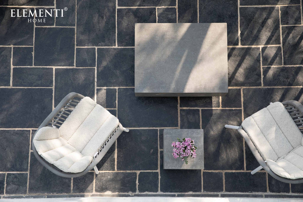 Overhead view of the Elementi Tevere Series Square Coffee Table in Space Grey, styled with two cushioned chairs on a modern stone-patterned patio.