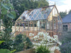 Alton Cedar Structure Cheltenham Victorian Greenhouse surrounded by a vibrant flower garden.