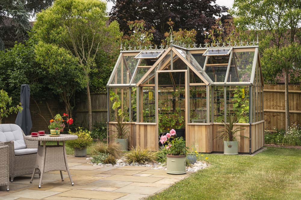 Rear perspective of the Alton Cedar Structure Durham Greenhouse 7x12, highlighting the structure’s spacious design and detailed craftsmanship.