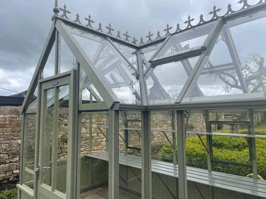 A close-up of the intricate cedar craftsmanship in the Alton Cedar Structure Durham Greenhouse, highlighting its natural finish.