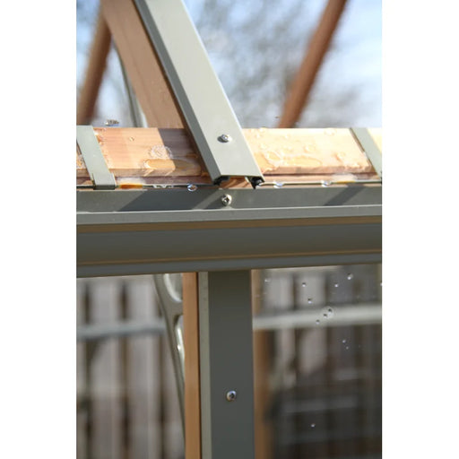 Close-up of the Alton Cedar Structure Victorian Accessories - ADD ON Only frame, featuring metal and wooden supports with elegant Victorian cresting, bolts, and glass panels.