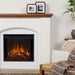 Real Flame Anika electric fireplace in living room close-up with faux tile surround, warm flame effect, wood mantel, framed photos, and cozy armchair with throw blanket beside it