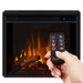 Hand holding Real Flame Anika remote control in front of lit electric fireplace insert displaying vivid orange flame effect with glowing log bed