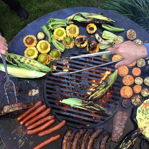 Outdoor cooking on the Arteflame Euro 40" Black Label Grill with a variety of grilled vegetables and meats on its expansive cooktop.