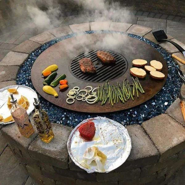 Cooking on Arteflame Classic 40" Grill, succulent meats and colorful vegetables, outdoor culinary action.