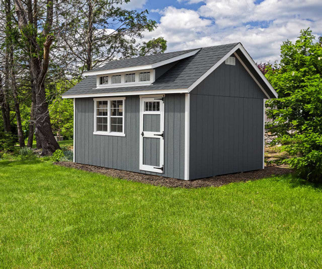Ez-Fit Skyview Shed Kit installed in backyard setting with gray siding, white trim, transom windows, and asphalt shingle roof.