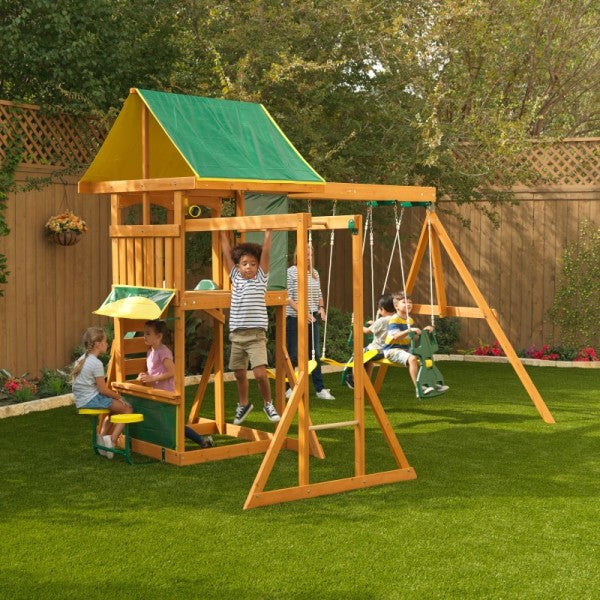 Kids playing on the outdoor wooden playset